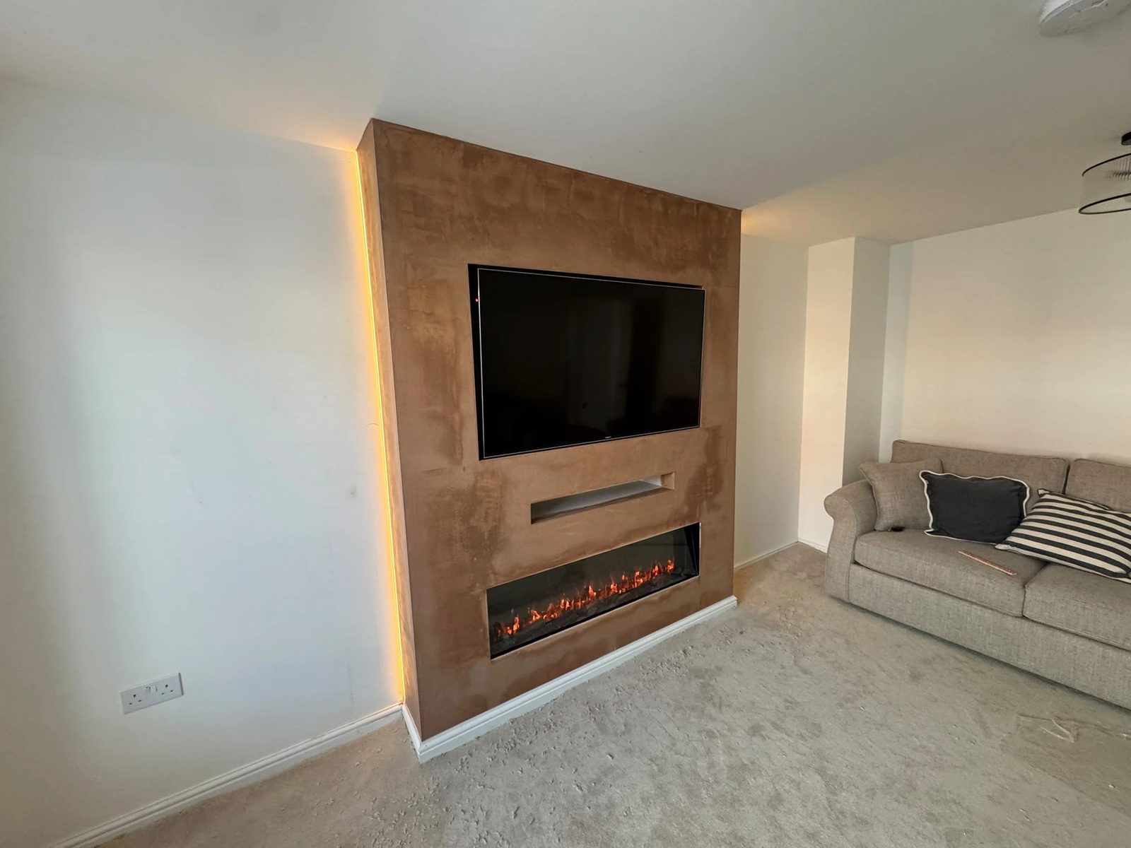 Stage 3 — finished media wall with TV, fire and accent lighting
