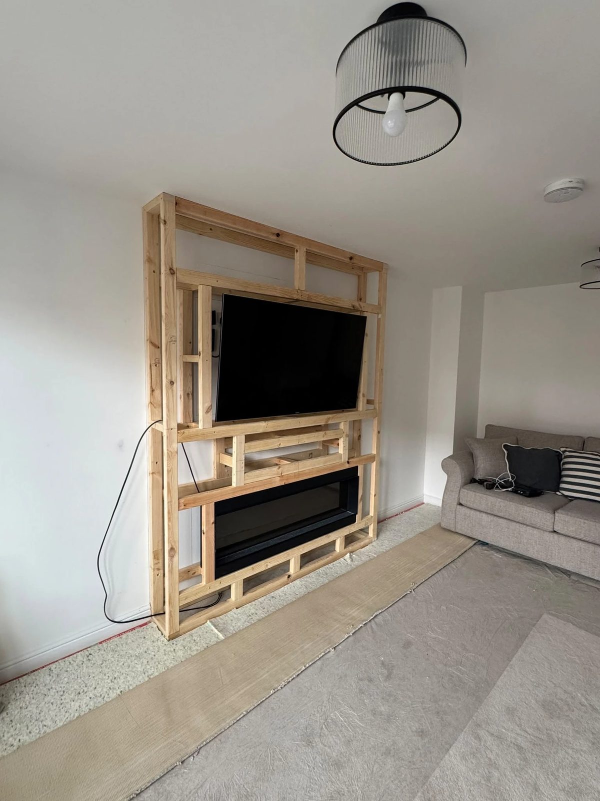 Stage 2 — timber frame built around the TV and fire